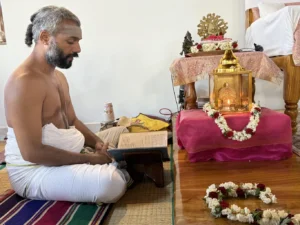 3. A Vedic scholar reciting mantras from the Krishna Yajurveda on the auspicious day dedicated to worshipping Goddess Durga.