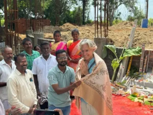 4. The architect of the new satsang hall receiving a shawl as in custom on this occasion from the contractors.