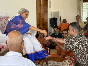 4. A satsang member receiving prasad from Sri Ganga Maa during one of the days of Navaratri celebrations 2024.